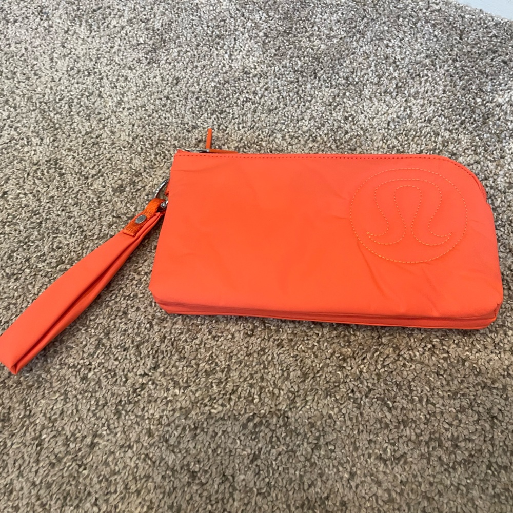 lululemon athletica bright orange curved wristlet